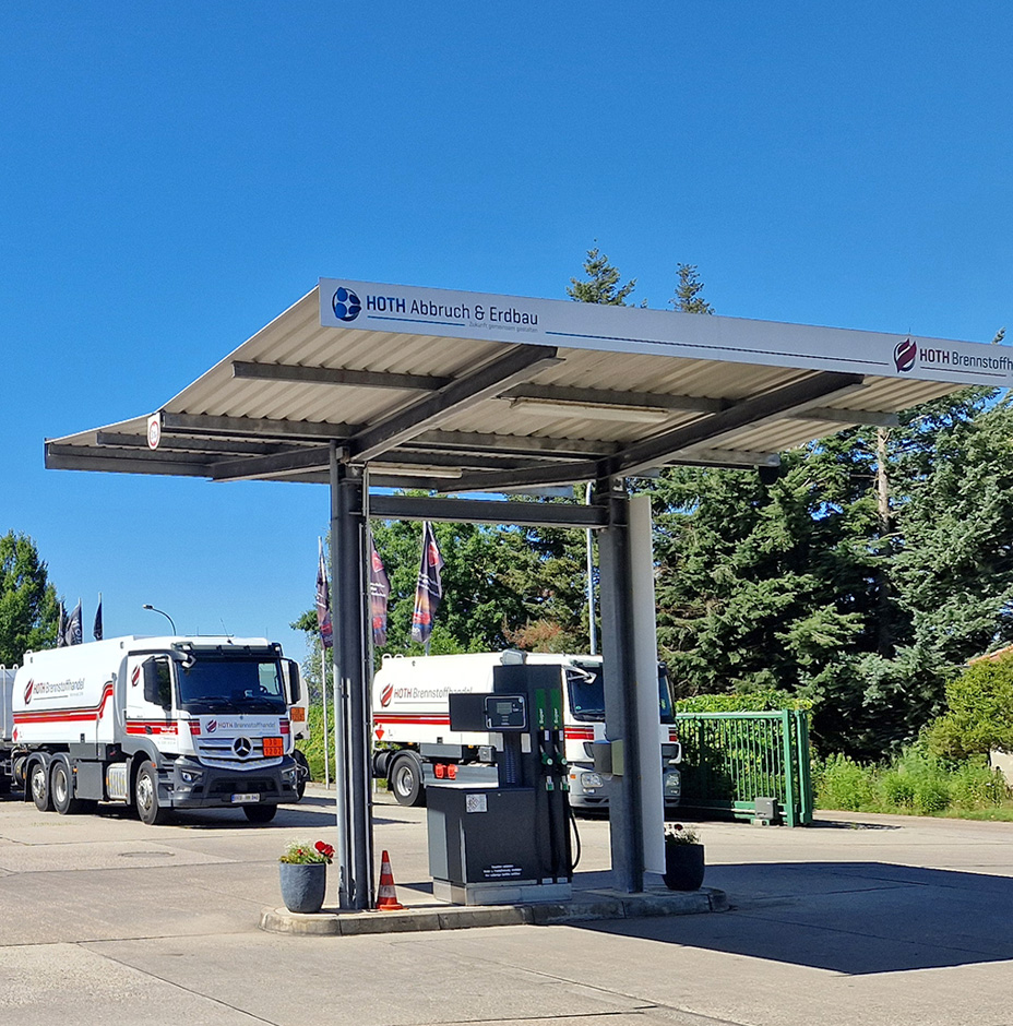 Im Vordergrund die Tankstelle von Hoth Brennstoffhandel in Hohenstücken, im Hintergrund die Tankfahrzeuge Im Vordergrund die Tankstelle von Hoth Brennstoffhandel in Hohenstücken, im Hintergrund die Tankfahrzeuge